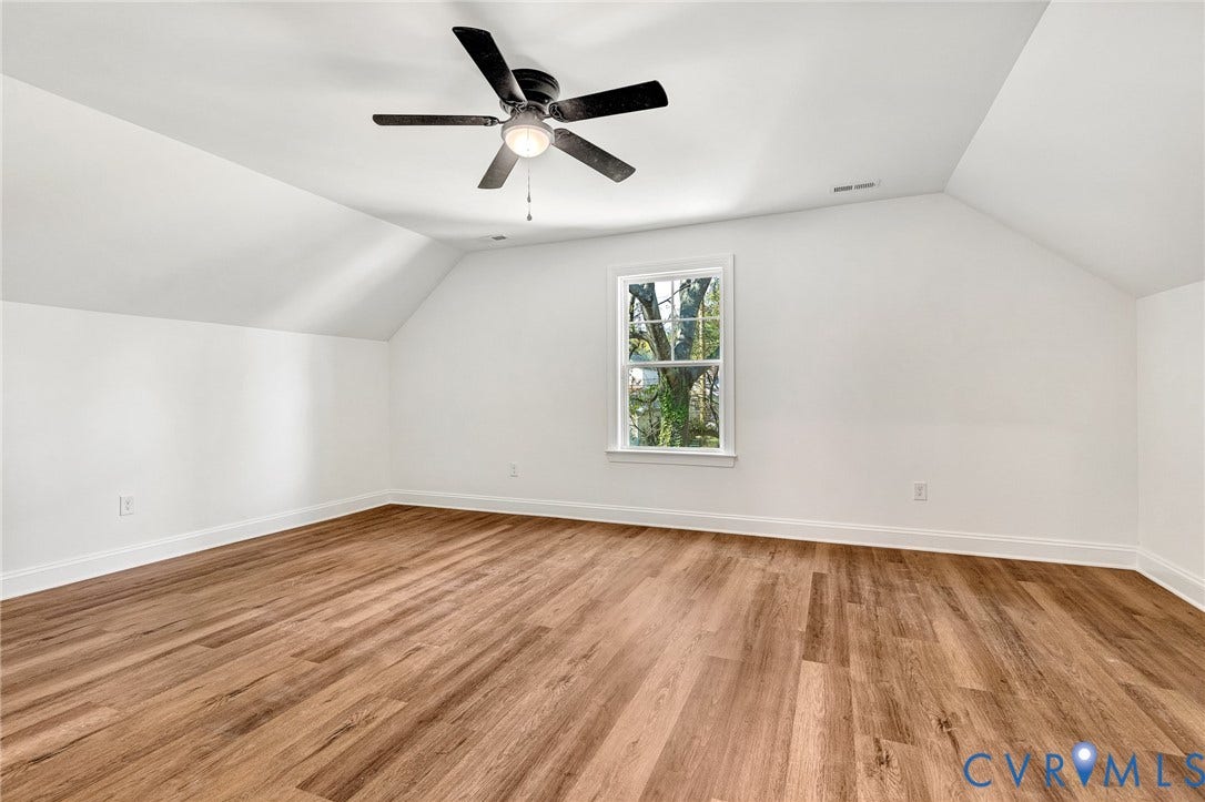 1807.5 Gordon Avenue, Oak Grove, Oak Grove, VA 23224 Room with slanted ceilings, wood-finish flooring, a central ceiling fan with an integrated light fixture, and a single-pane window