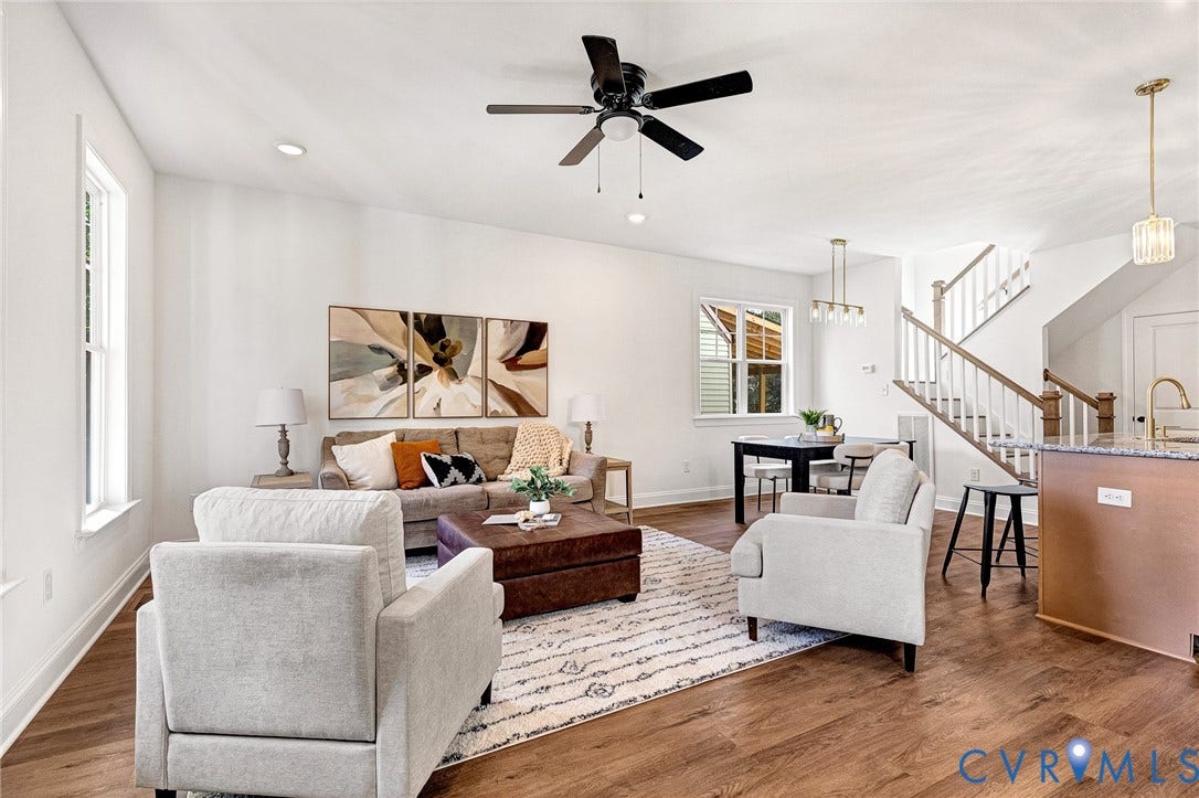 1807.5 Gordon Avenue, Oak Grove, Oak Grove, VA 23224 Open-concept living space featuring wood-finish flooring, a central ceiling fan, multi-pendant lighting, and a staircase with a wooden handrail