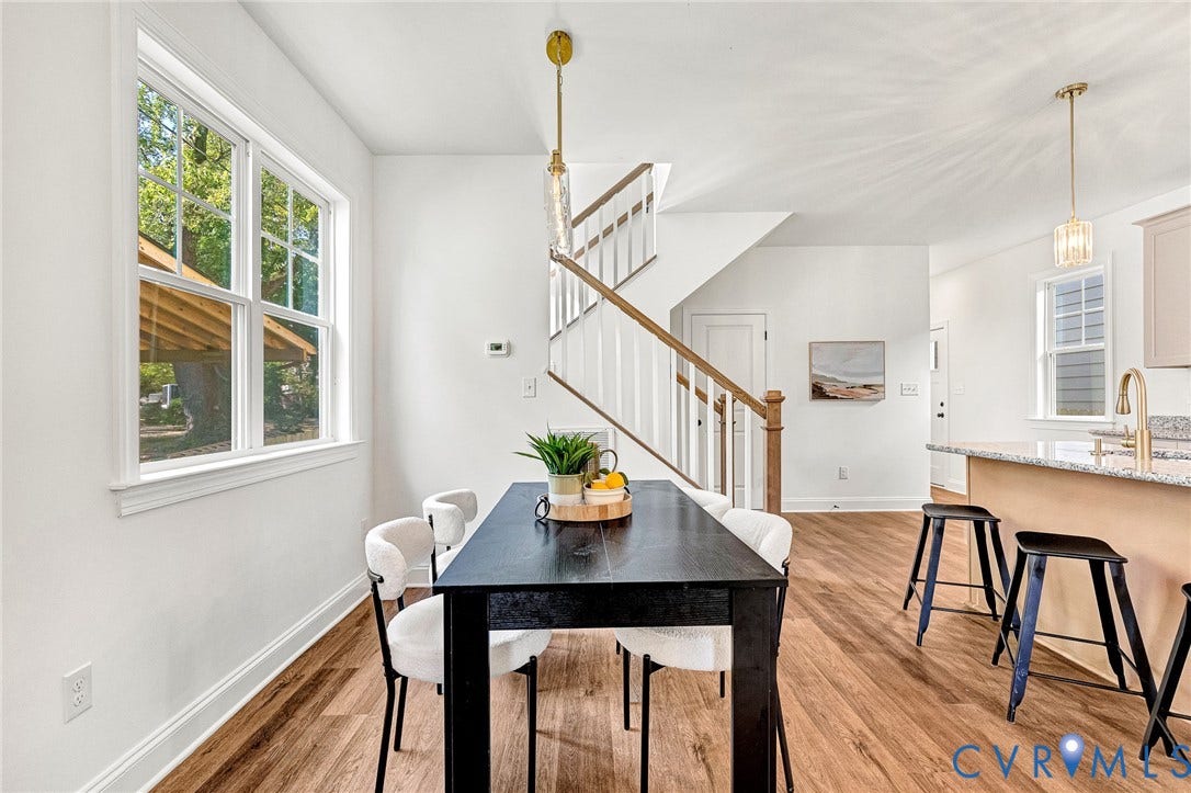 1807.5 Gordon Avenue, Oak Grove, Oak Grove, VA 23224 Wood-finish flooring throughout, staircase with wood handrail, kitchen island with stone-surface countertop, and hanging pendant lighting