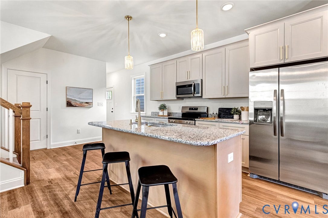 1807.5 Gordon Avenue, Oak Grove, Oak Grove, VA 23224 Kitchen featuring a center island with stone-finish countertops, stainless steel appliances, shaker-style cabinetry, and wood-finish flooring