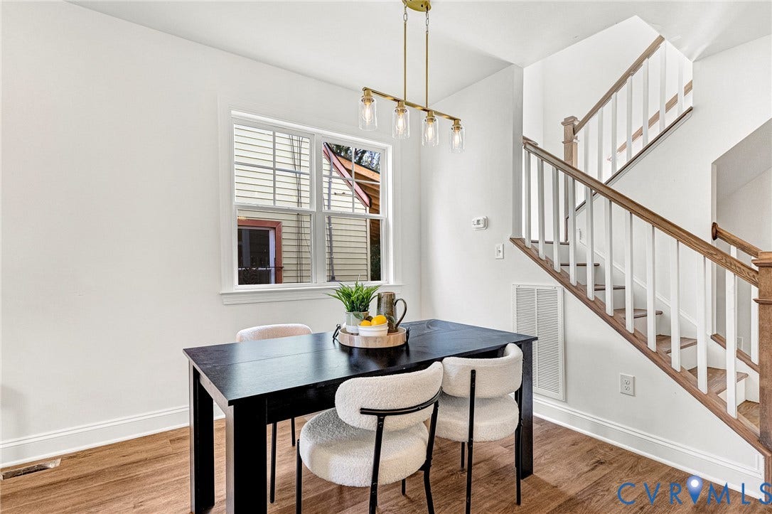 1807.5 Gordon Avenue, Oak Grove, Oak Grove, VA 23224 Staircase featuring white balusters and a wood-finish handrail, complemented by linear multi-light pendant lighting and wood-finish flooring