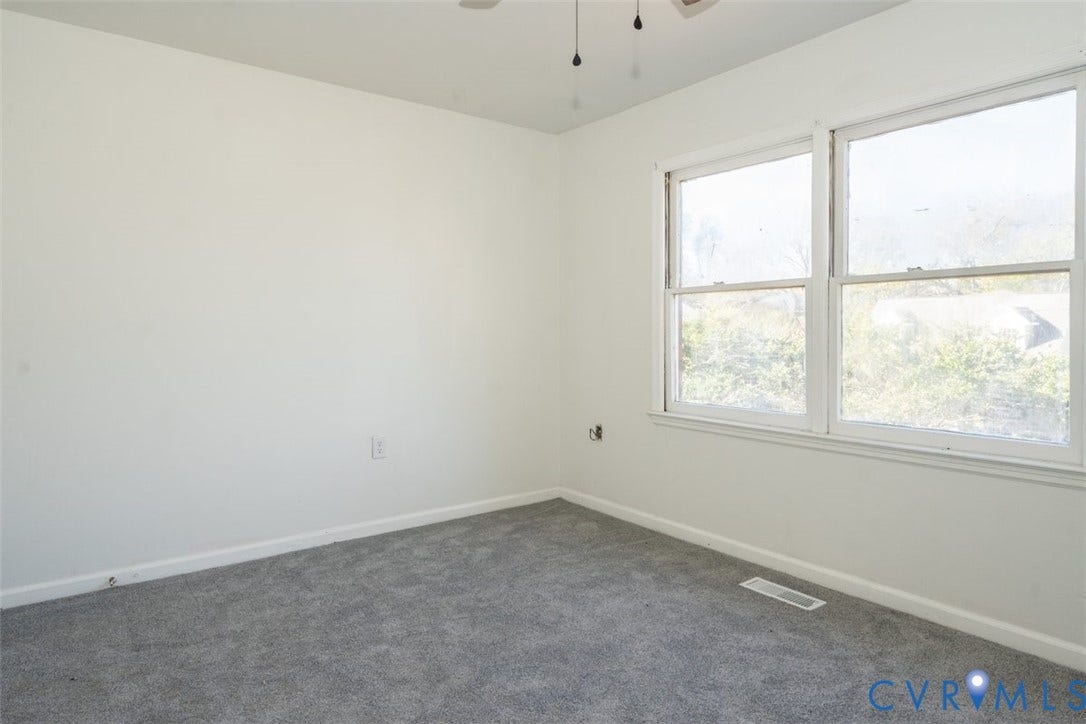 2358 Hill Street, #G, Petersburg, VA 23803 Neutral-toned carpeting, white walls, and large windows providing natural light, finished with an attached ceiling fan