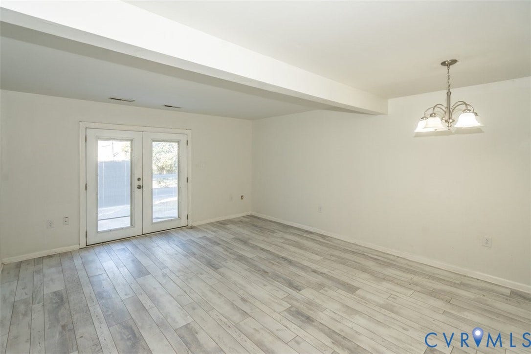 2358 Hill Street, #G, Petersburg, VA 23803 Interior space featuring wood-finish flooring, double glass panel doors, and a multi-arm metal chandelier with frosted glass shades
