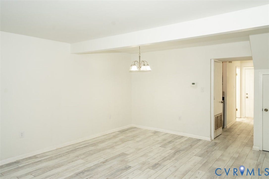 2358 Hill Street, #G, Petersburg, VA 23803 Neutral-toned wood-finish flooring, white walls, and a multi-light brushed nickel pendant fixture