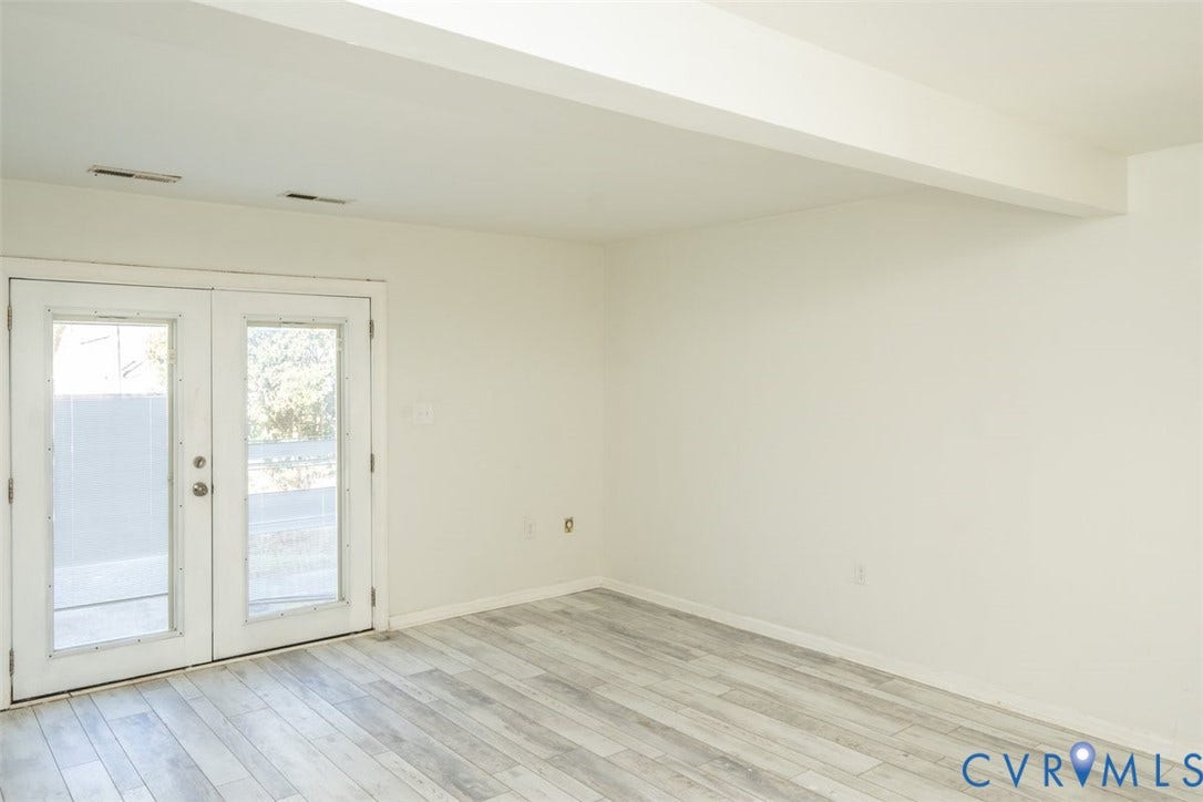 2358 Hill Street, #G, Petersburg, VA 23803 Neutral interior space featuring wood-finish flooring, white walls, and white French doors with glass inserts