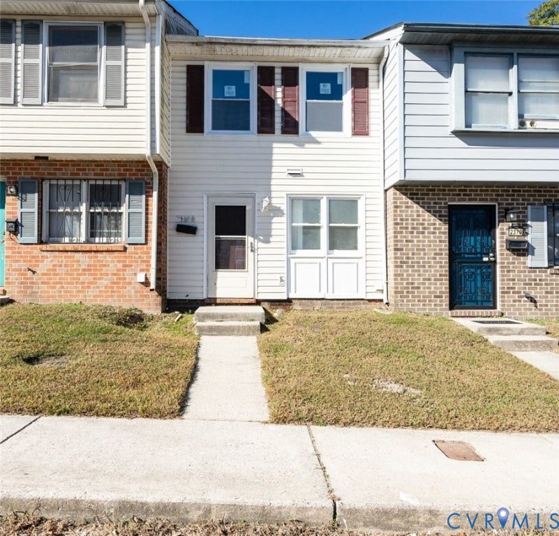 2358 Hill Street, #G, Petersburg, VA 23803 Multi-level townhome exterior featuring horizontal vinyl siding, dual-pane windows with decorative shutters, and concrete front entry steps