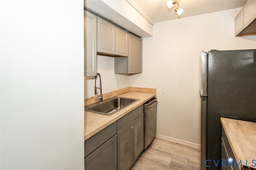 2358 Hill Street, #G, Petersburg, VA 23803 Kitchen featuring grey cabinetry, wood-finish countertops, stainless steel sink with a high-arc faucet, integrated dishwasher, and wood-finish flooring
