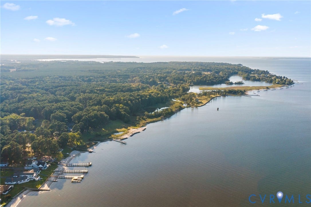 Extensive waterfront acreage featuring multiple private docks, direct shoreline access, and mature wooded canopy