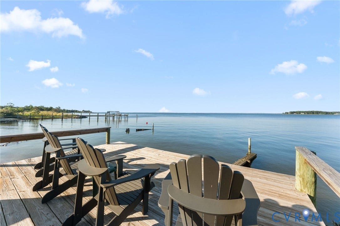 Wood-plank dock featuring a post-and-rail system and an extended pier reaching into the water