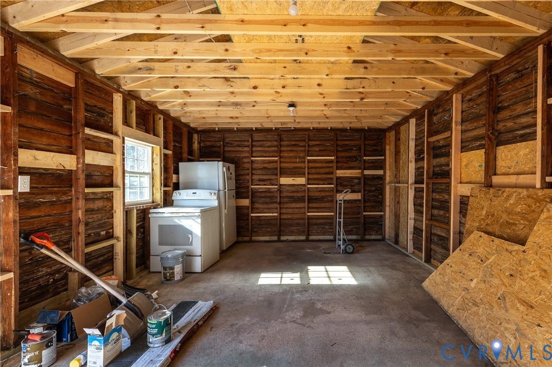 6280 Monahan Road, Henrico, VA 23231 Interior space featuring exposed wood-frame wall construction, vaulted rafters, concrete flooring, and a single-pane window