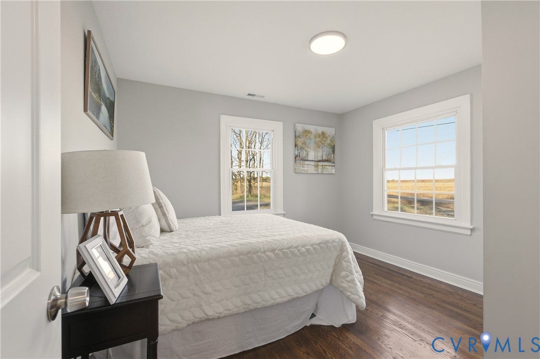 6280 Monahan Road, Henrico, VA 23231 Interior room featuring wood-finish flooring, two large windows with grid muntins, and neutral wall paint