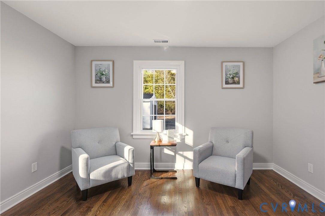 6280 Monahan Road, Henrico, VA 23231 Neutral-toned interior space featuring wood-finish flooring and a multi-pane window with white trim
