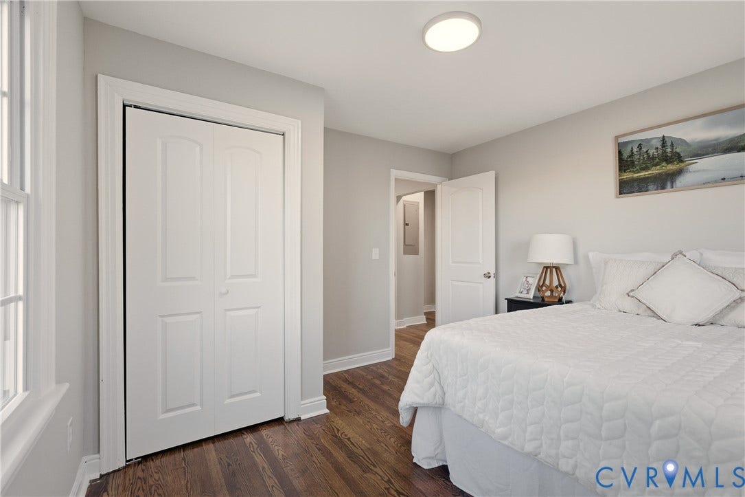 6280 Monahan Road, Henrico, VA 23231 Interior room featuring wood-finish flooring, white paneled doors, neutral wall paint, and a ceiling-mounted flush lighting fixture