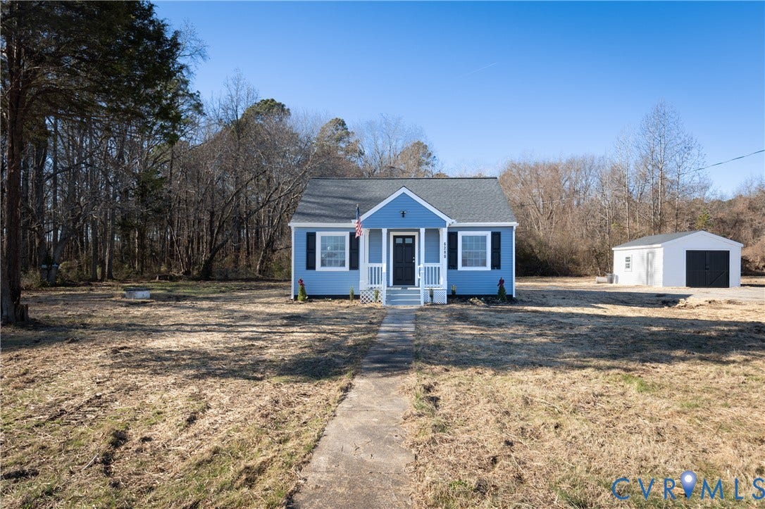 6280 Monahan Road, Henrico, VA 23231 Single-story exterior featuring blue siding, a covered front porch, dark-toned shutters, and a detached garage