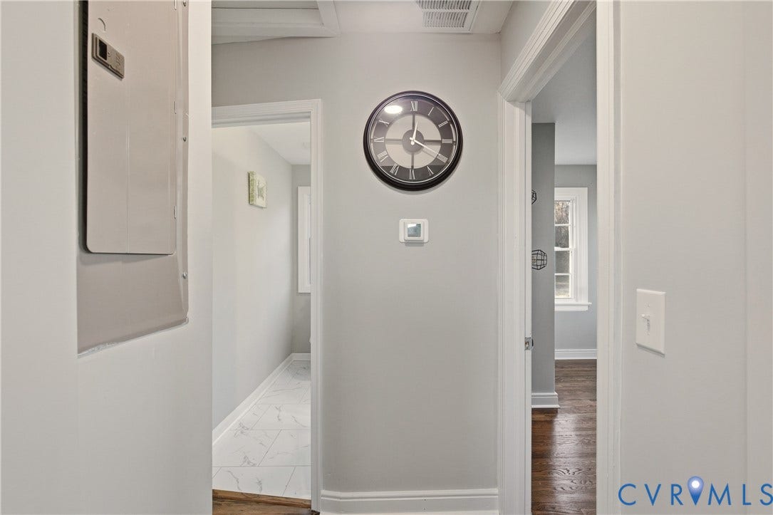 6280 Monahan Road, Henrico, VA 23231 Hallway featuring neutral wall paint, wood-finish flooring, and white door trim