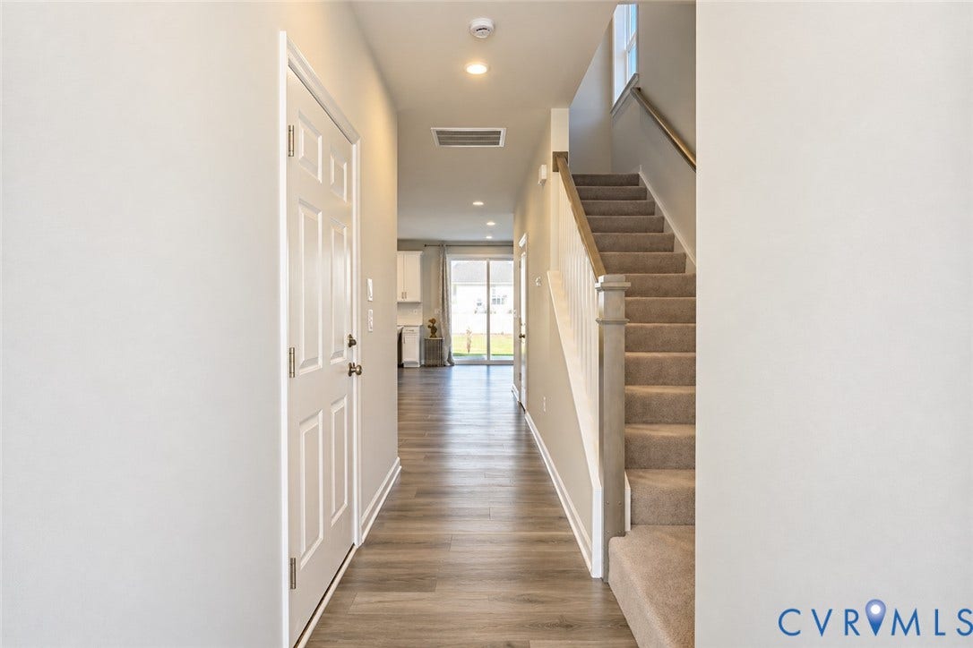 500 Rivanna Hill Way, Glen Allen, VA 23060 Entryway featuring wood-finish flooring, a six-panel door, carpeted staircase with a wooden handrail, and recessed lighting