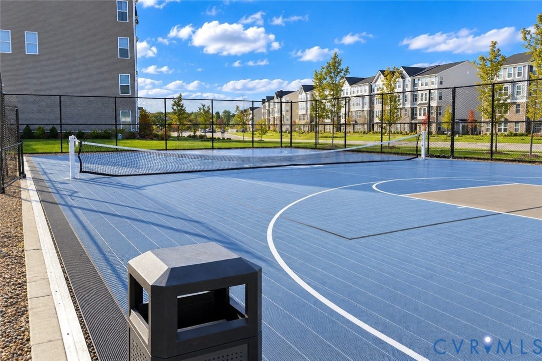 500 Rivanna Hill Way, Glen Allen, VA 23060 Multi-purpose sports court featuring a high-performance blue surface, tennis net, basketball hoop area, and perimeter chain-link fencing