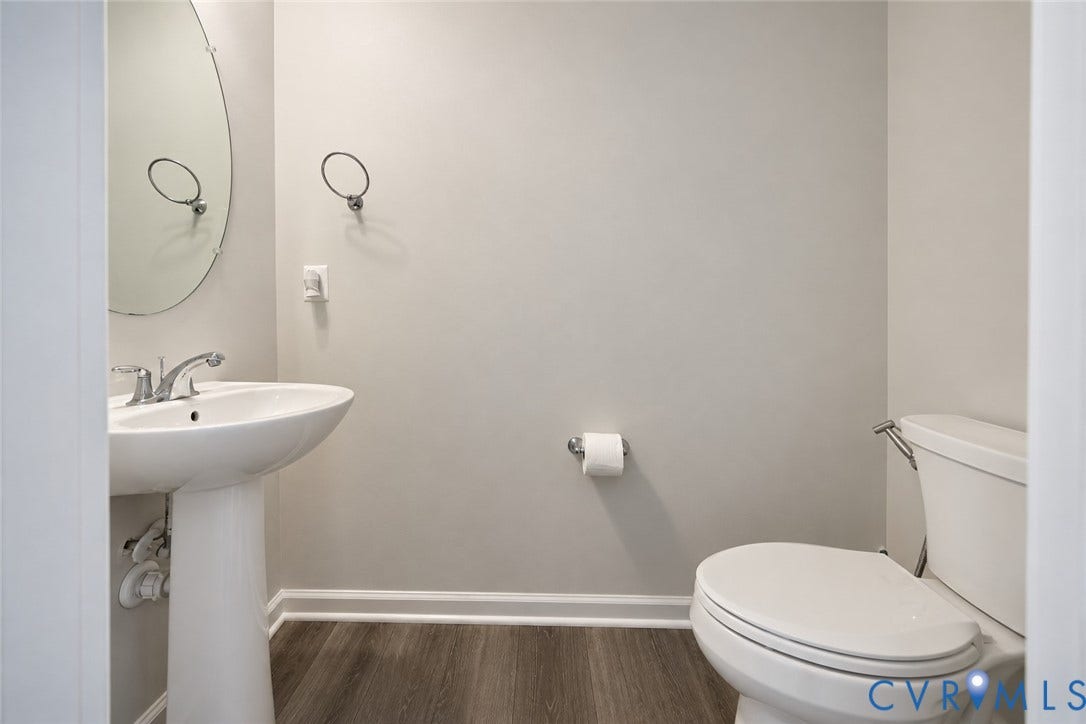 500 Rivanna Hill Way, Glen Allen, VA 23060 Pedestal sink with polished chrome faucet, oval frameless mirror, and wood-finish flooring