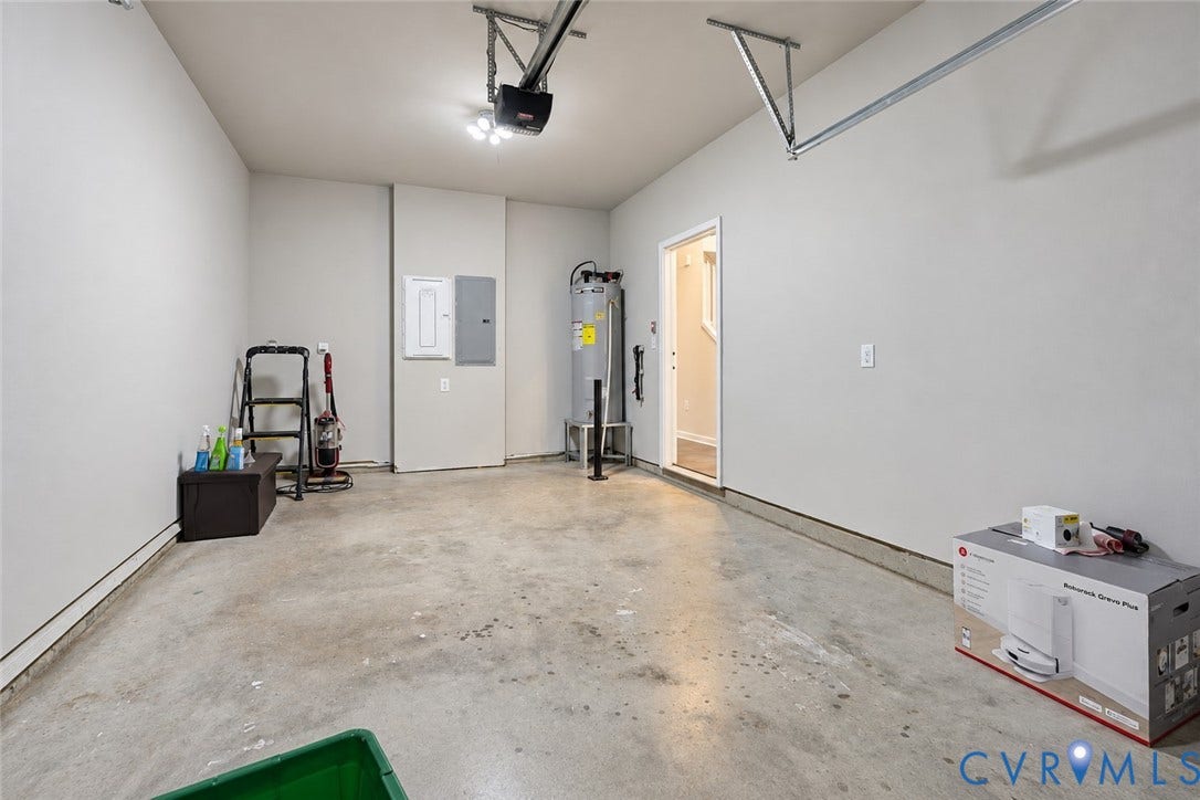 500 Rivanna Hill Way, Glen Allen, VA 23060 Finished garage space featuring smooth wall surfaces, concrete flooring, overhead automatic garage door opener, dedicated electrical panel, and interior water heater unit