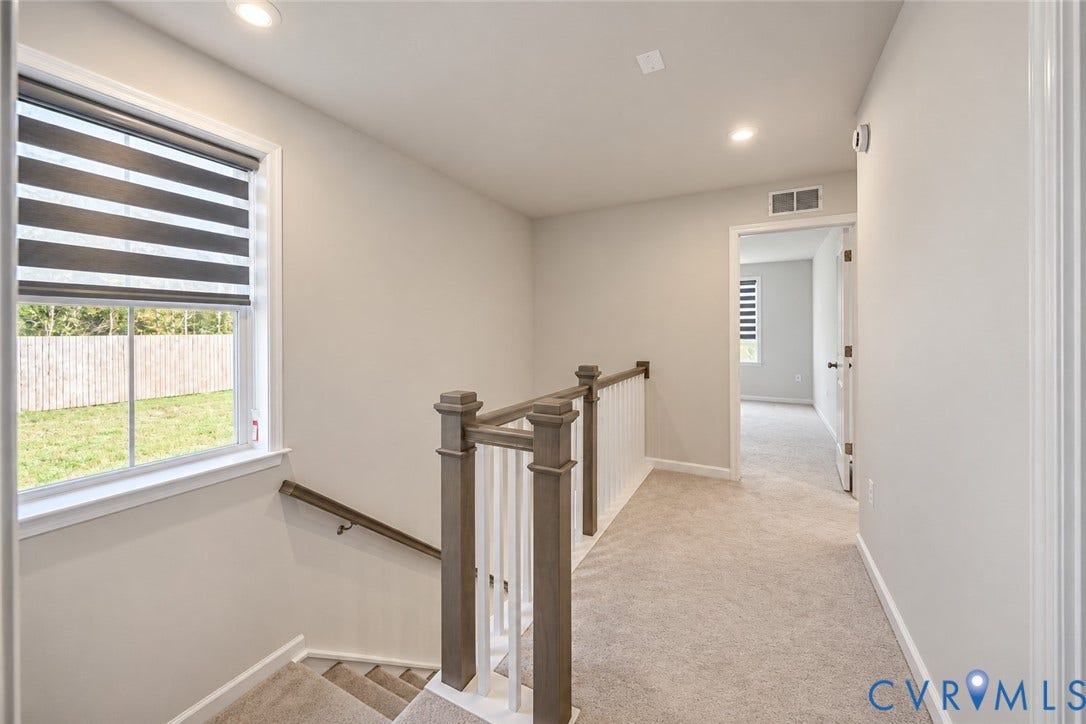 500 Rivanna Hill Way, Glen Allen, VA 23060 Staircase featuring wood-finish railings, white balusters, recessed lighting, and neutral-tone carpeting