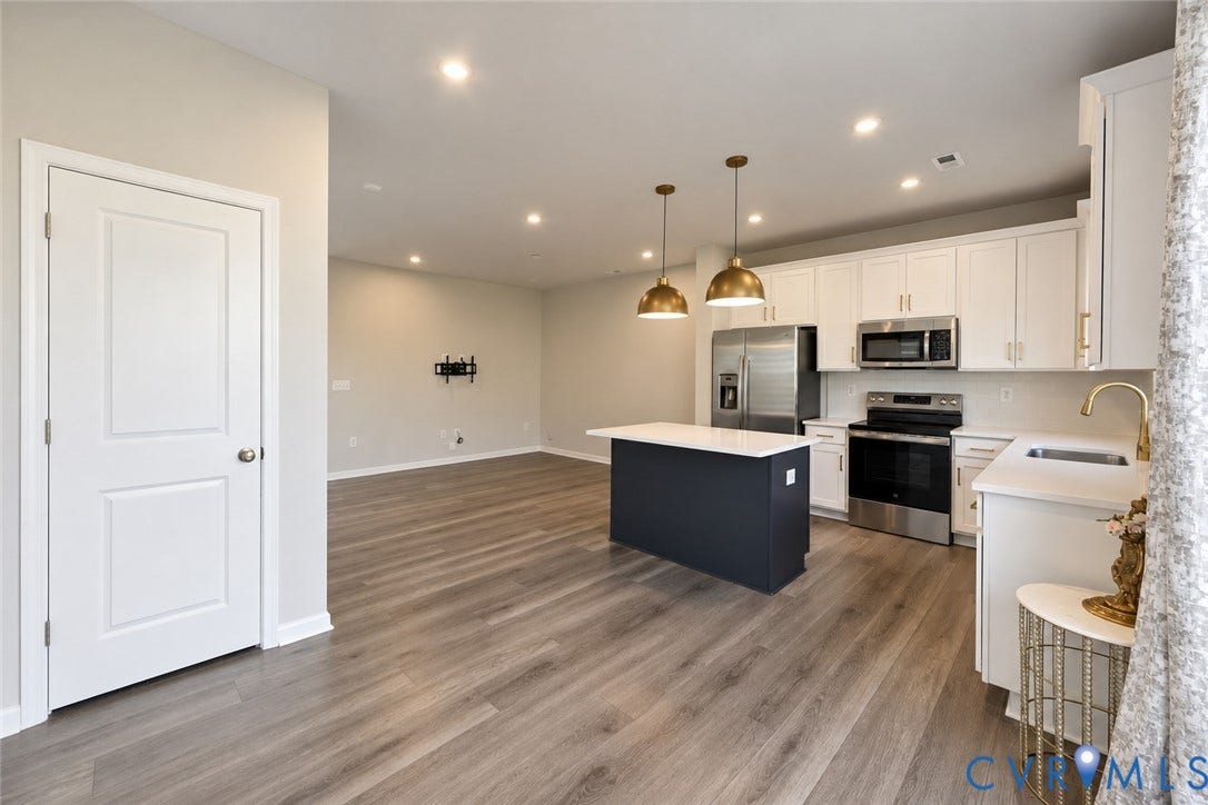 500 Rivanna Hill Way, Glen Allen, VA 23060 Kitchen featuring white cabinetry, quartz countertops, a dark-toned center island, stainless steel appliances, and wood-finish flooring