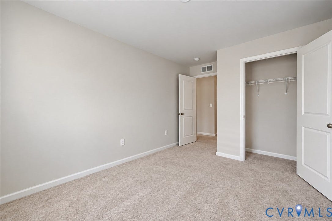 500 Rivanna Hill Way, Glen Allen, VA 23060 Neutral interior featuring wall-to-wall carpeting, two-panel interior doors, and a reach-in closet with integrated shelving