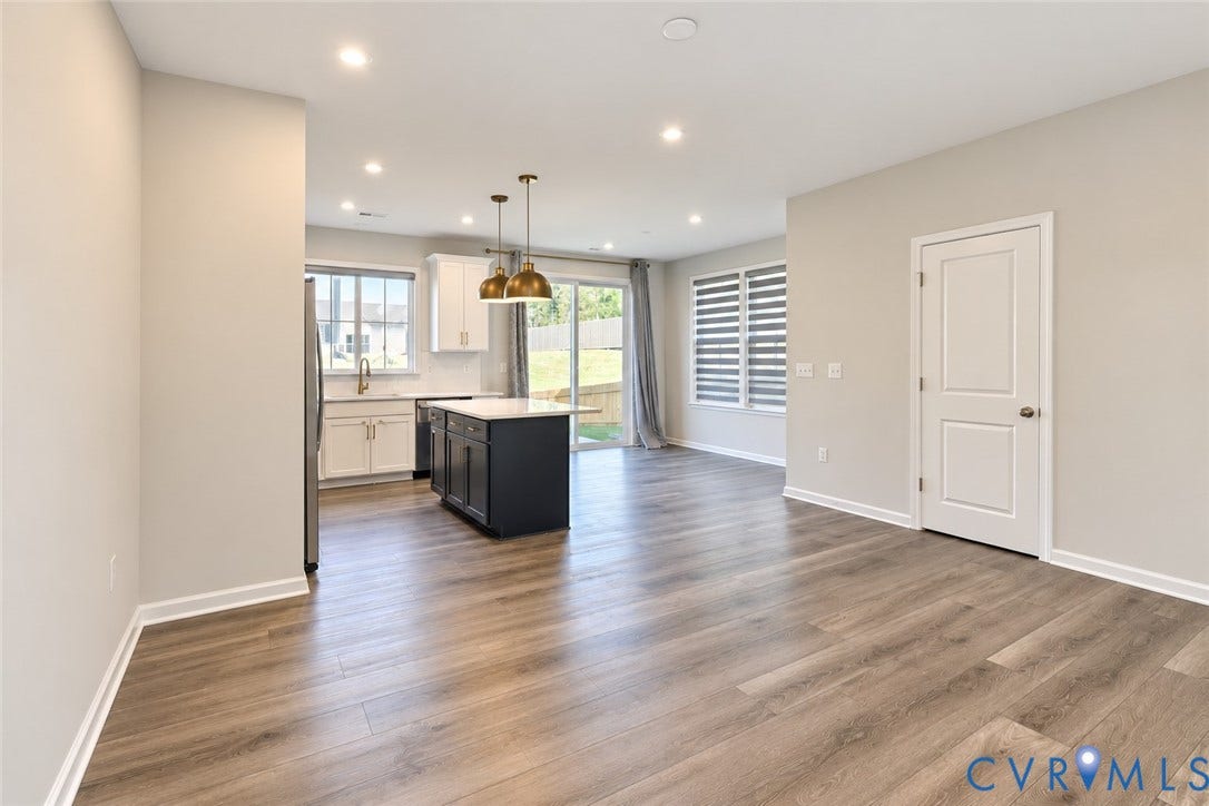 500 Rivanna Hill Way, Glen Allen, VA 23060 Kitchen featuring wood-finish flooring, a center island with a stone countertop, dual metal pendant lighting, and white cabinetry