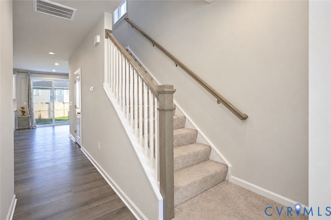 500 Rivanna Hill Way, Glen Allen, VA 23060 Staircase featuring white balusters, wood-finish handrail, and carpeted treads, complemented by wood-finish flooring and recessed lighting