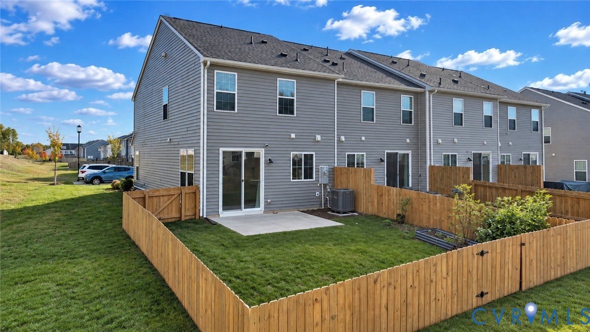 500 Rivanna Hill Way, Glen Allen, VA 23060 Exterior featuring horizontal vinyl siding, a fenced-in rear lawn, concrete patio, and sliding glass entry door