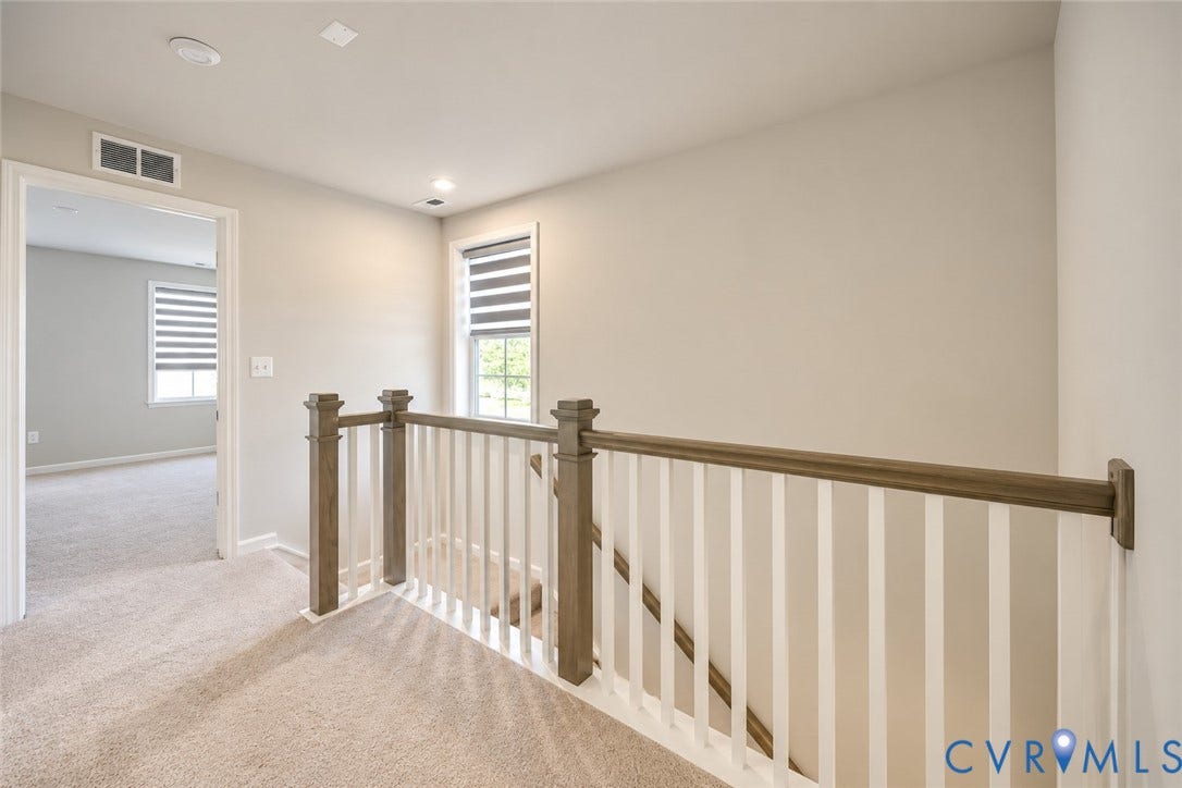500 Rivanna Hill Way, Glen Allen, VA 23060 Neutral-toned carpeting, wood-finish handrail, white vertical balusters, and dual-layered window blinds
