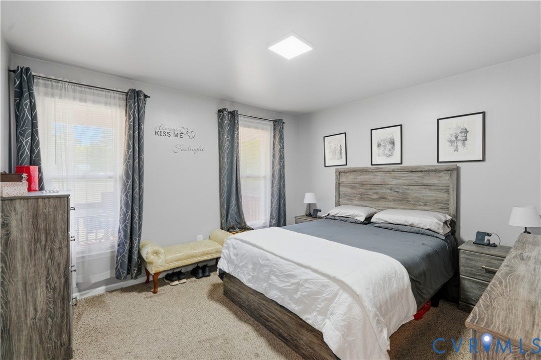 16401 Anderson Drive, Disputanta, VA 23833 Neutral-toned room featuring wall-to-wall carpeting, flush-mount lighting, and dual windows