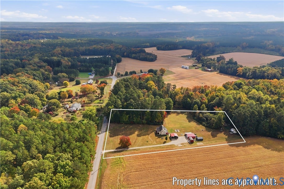 16401 Anderson Drive, Disputanta, VA 23833 Expansive rural acreage featuring mature wooded sections, open grass fields, a primary residence, and multiple detached outbuildings
