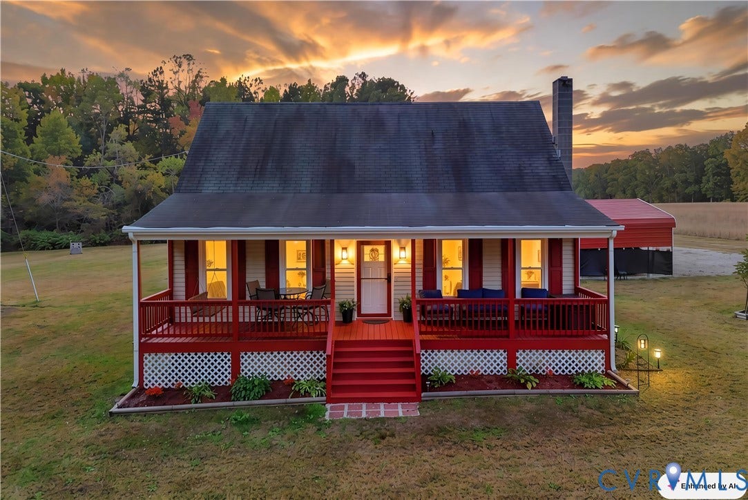 16401 Anderson Drive, Disputanta, VA 23833 Gabled exterior featuring a covered front porch, red wood-finish decking, lattice skirting, and a chimney
