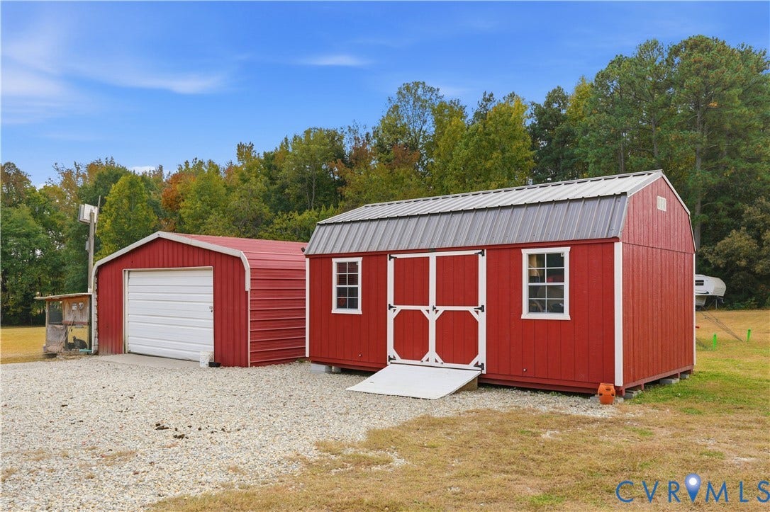 16401 Anderson Drive, Disputanta, VA 23833 Detached metal storage structure and separate one-car garage featuring gravel drive access