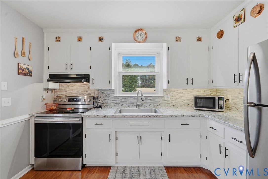16401 Anderson Drive, Disputanta, VA 23833 Kitchen featuring white cabinetry, stone-finish countertops, decorative tile backsplash, stainless steel sink, and wood-finish flooring