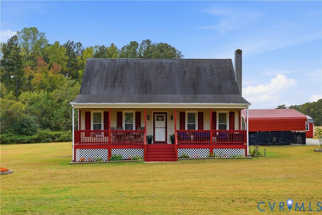 16401 Anderson Drive, Disputanta, VA 23833 Single-story residence featuring a covered front porch with red railings, lattice foundation skirting, exterior shutters, and an attached chimney