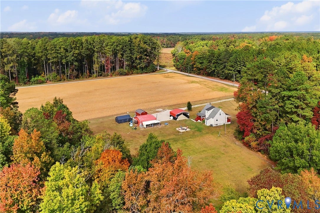 16401 Anderson Drive, Disputanta, VA 23833 Expansive acreage featuring cleared fields, mature tree lines, residential dwelling, and multiple detached outbuildings
