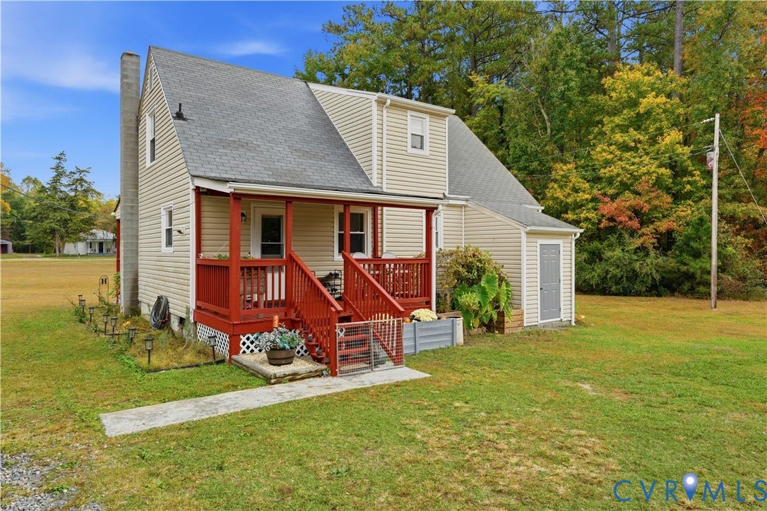 16401 Anderson Drive, Disputanta, VA 23833 Exterior featuring beige vinyl siding, a covered porch with red painted wood railing, an asphalt shingle roof, and an exterior masonry chimney