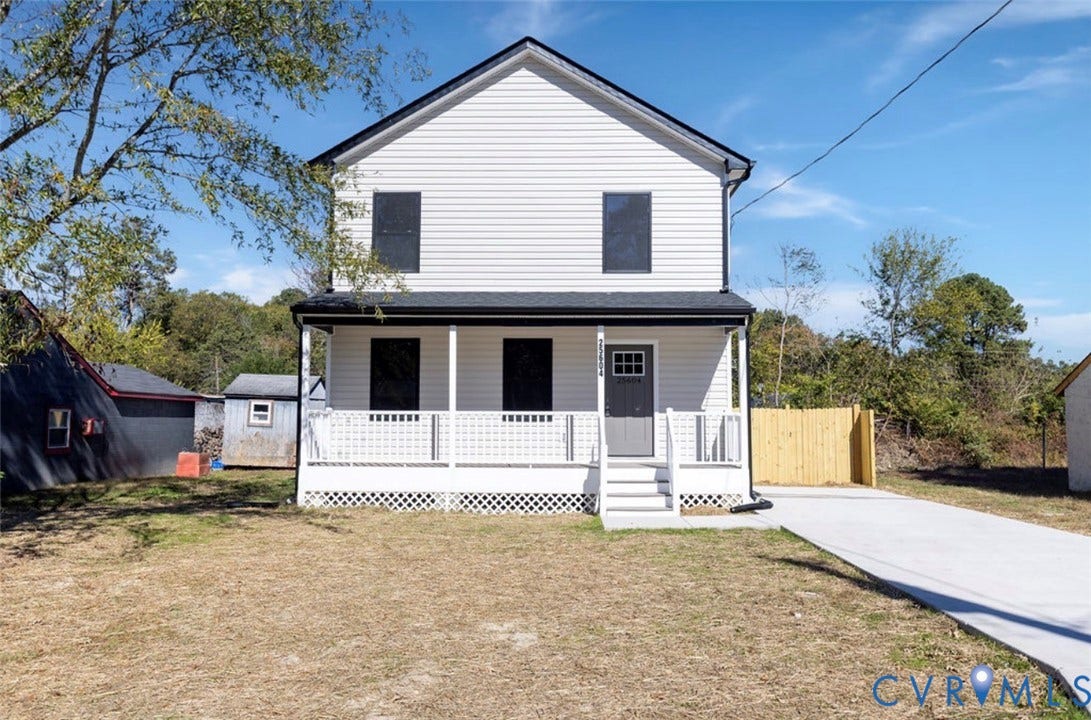 25604 Greensville Avenue, West Petersburg, Dinwiddie, VA 23803 Two-story residence featuring white horizontal siding, a covered front porch with lattice skirting, a concrete driveway, and a fenced side yard
