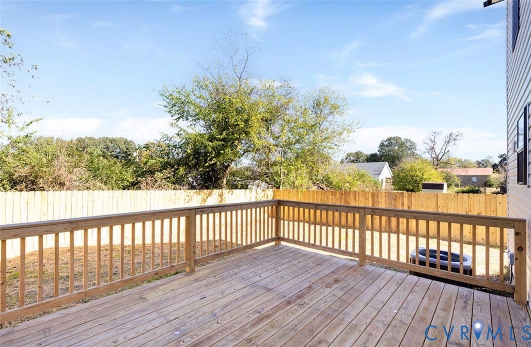 25604 Greensville Avenue, West Petersburg, Dinwiddie, VA 23803 Elevated wood deck featuring vertical wood balusters and a wood privacy fence enclosing the backyard