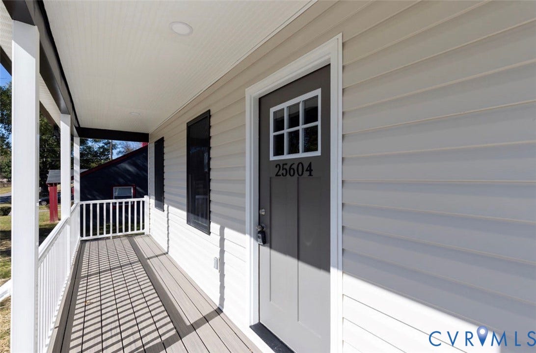 25604 Greensville Avenue, West Petersburg, Dinwiddie, VA 23803 Covered front porch featuring white railing, horizontal vinyl siding, recessed ceiling lighting, and a six-panel front door with a glass inlay