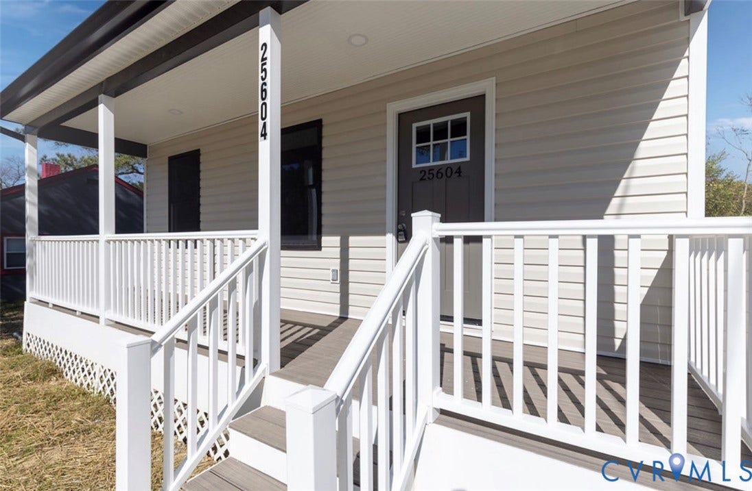 25604 Greensville Avenue, West Petersburg, Dinwiddie, VA 23803 Covered front porch featuring light-colored horizontal siding, white railing, recessed lighting, and a single-entry door with a glass-pane insert