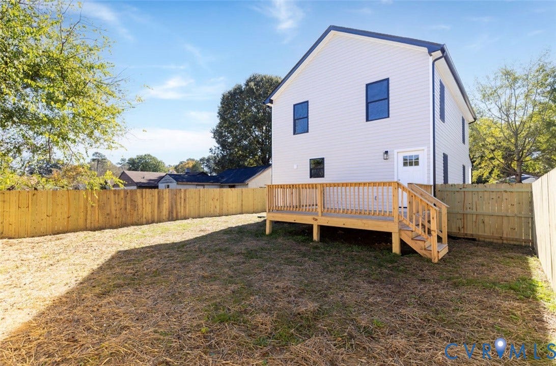 25604 Greensville Avenue, West Petersburg, Dinwiddie, VA 23803 Two-story exterior with light-colored siding, elevated wood deck with stair access, and enclosed fenced backyard