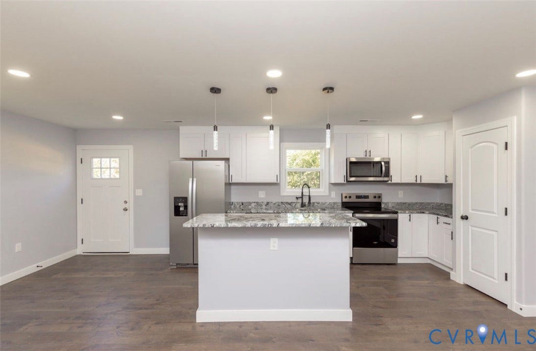 25604 Greensville Avenue, West Petersburg, Dinwiddie, VA 23803 Kitchen featuring white shaker-style cabinetry, stone-surface countertops, wood-finish flooring, a central island, and stainless steel appliances