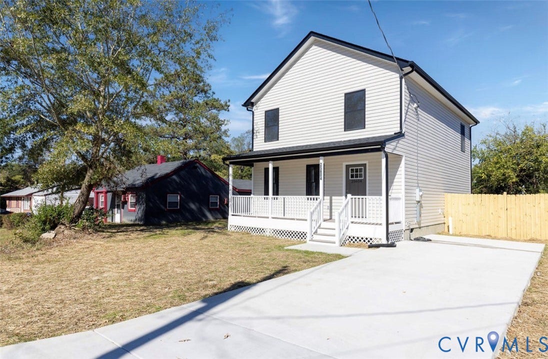 25604 Greensville Avenue, West Petersburg, Dinwiddie, VA 23803 Two-story vinyl siding exterior featuring a covered front porch with lattice skirting and a concrete driveway