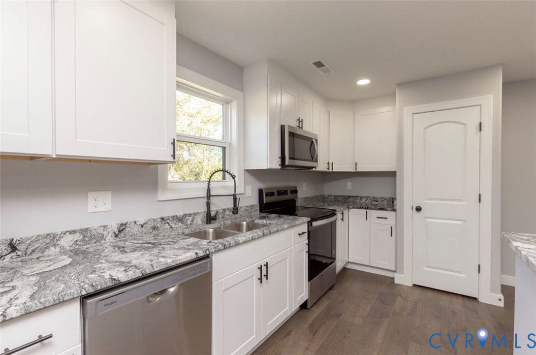 25604 Greensville Avenue, West Petersburg, Dinwiddie, VA 23803 Kitchen featuring white shaker-style cabinetry, stone-patterned countertops, stainless steel appliances, a gooseneck faucet, and wood-finish flooring
