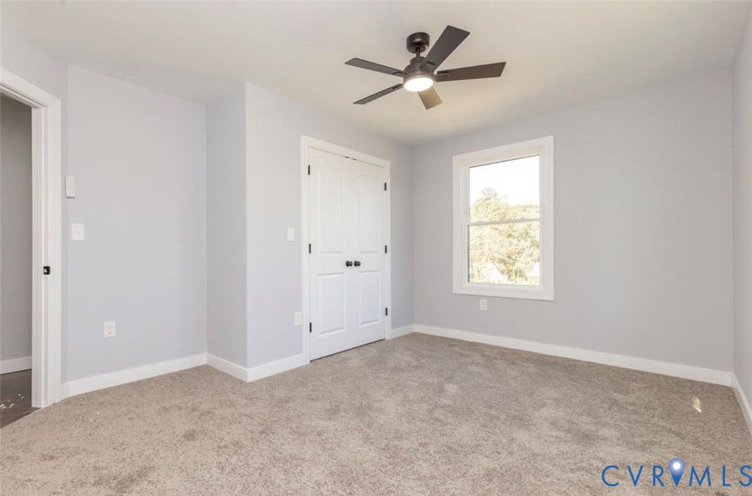 25604 Greensville Avenue, West Petersburg, Dinwiddie, VA 23803 Neutral-toned wall paint, wall-to-wall carpeting, dual-door closet, multi-pane window, and integrated ceiling fan with lighting