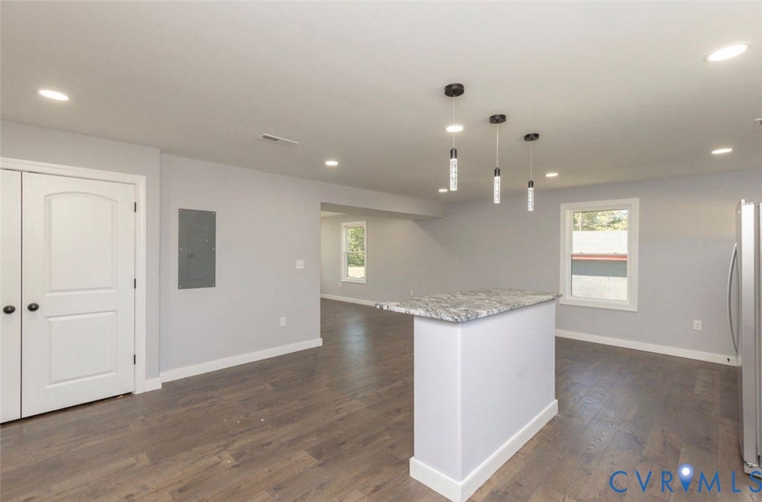 25604 Greensville Avenue, West Petersburg, Dinwiddie, VA 23803 Kitchen island with stone-finish countertop, wood-finish flooring, recessed lighting, and three glass pendant lights