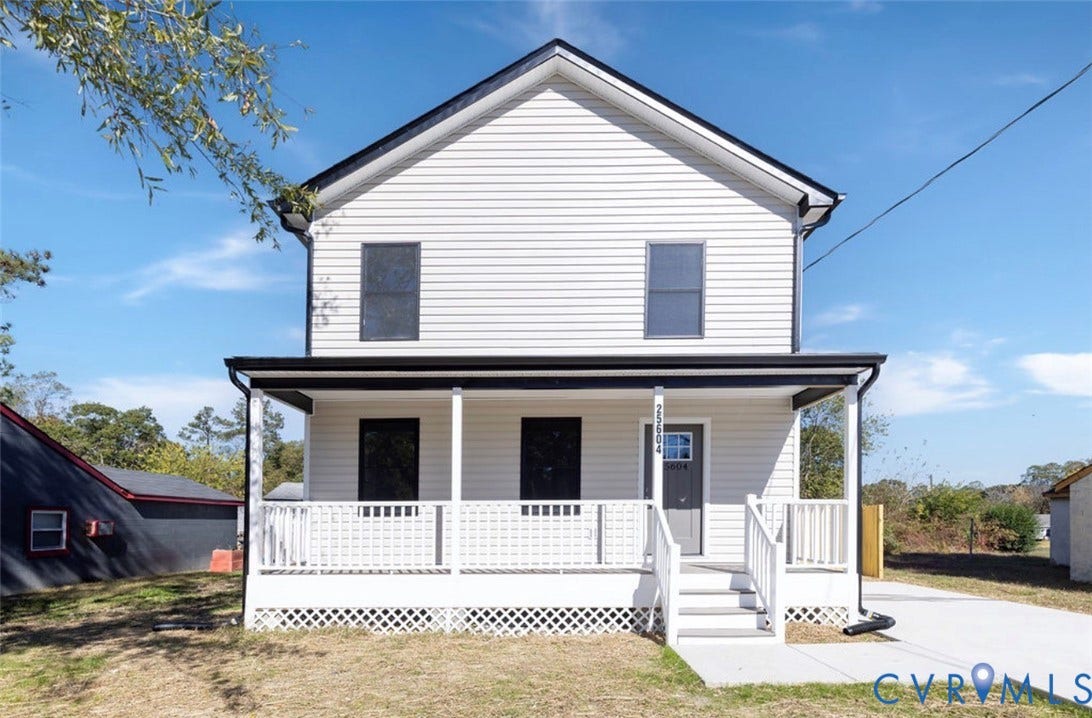 25604 Greensville Avenue, West Petersburg, Dinwiddie, VA 23803 Two-story exterior featuring light-toned horizontal siding, a covered front porch with white lattice skirting, black-trimmed windows, and a concrete driveway