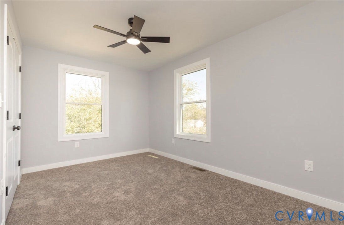 25604 Greensville Avenue, West Petersburg, Dinwiddie, VA 23803 Neutral interior featuring wall-to-wall carpeting, dual windows, and a ceiling fan with integrated lighting